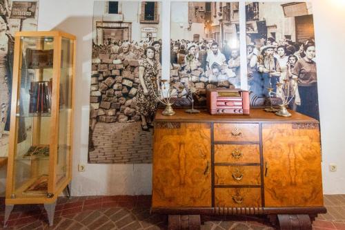 a room with a painting on the wall and a wooden cabinet at Hotel Utopía in Benalup Casas Viejas