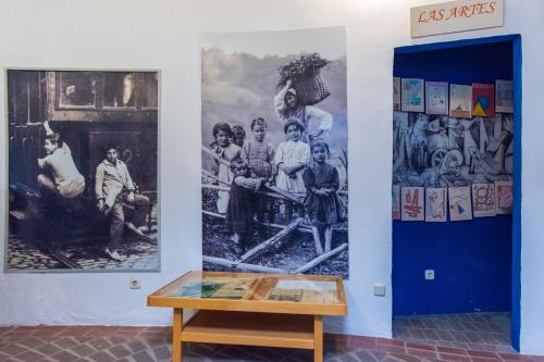 a room with paintings on the wall and a table at Hotel Utopía in Benalup Casas Viejas
