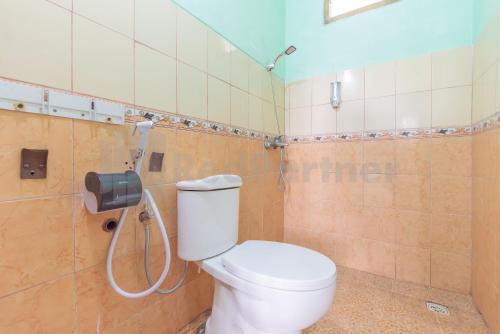 a bathroom with a toilet and a shower at Villa Sari Intan Ciater RedPartner in Subang