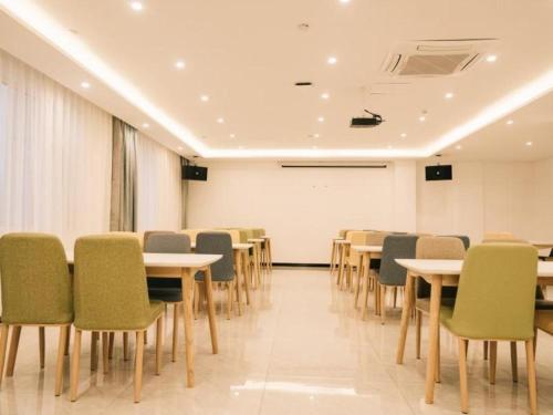 uma sala de conferências com mesas e cadeiras e um quadro branco em GEM Hotel Zibo Economic Development Zone Zibo Vocational Institute em Jinan