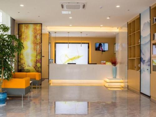 an office lobby with a large clock on the wall at GreenTree Inn Express Chuzhou Langya District Government Chuhe Road in Chuzhou