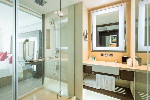 a bathroom with a shower and a sink at Novotel Nanjing Central in Nanjing