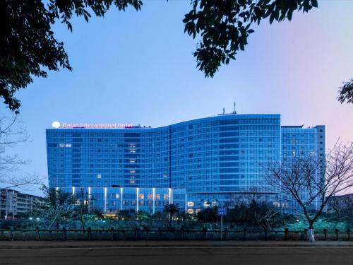 a large blue building with a sign on it at Balan International Hotel in Dujiangyan