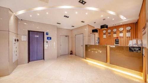 a hallway of a store with a purple door at Gangneung Four Season Hotel and Pension in Gangneung