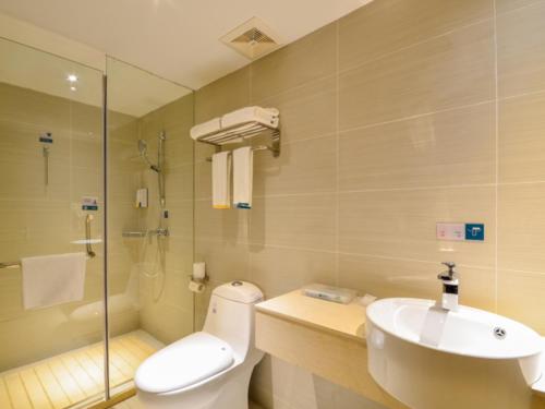 a bathroom with a toilet and a sink and a shower at City Comfort Inn Wuhan South Lake Zhongnan University of Economics and Law Fashion City in Liufangling