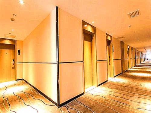 a row of elevators in a hallway in a building at City Comfort Inn Qingyuan Longtang Light Rail Changlong in Qingyuan