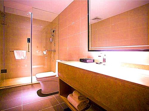 a bathroom with a sink and a toilet and a shower at City Comfort Inn Qingyuan Longtang Light Rail Changlong in Qingyuan