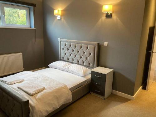 a bedroom with a bed with a headboard and a window at Promotion Half Price 2 Bedroom Flat in West Ealing in London