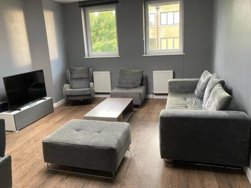 a living room with two couches and a tv at Promotion Half Price 2 Bedroom Flat in West Ealing in London
