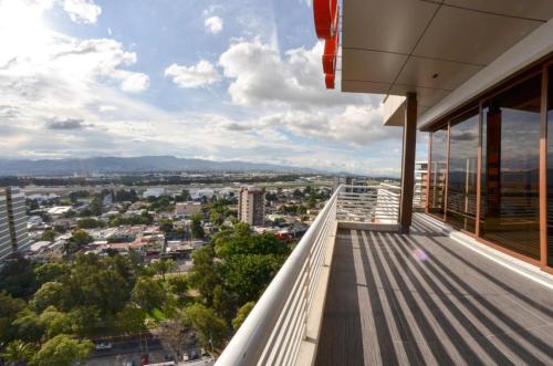 a balcony with a view of a city at ADRIATIKA Hotel Boutique Guatemala - Adults Only in La Aurora
