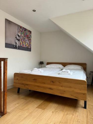 a bedroom with a wooden bed in a room at Hello Noordwijk - Zomerhuis Quarles van Uffordstraat 89 in Noordwijk