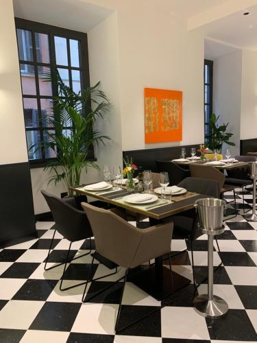 a dining room with tables and chairs on a checkered floor at Hotel Nord Nuova Roma in Rome