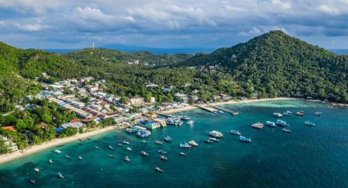an aerial view of a beach with boats in the water at Tao Island Boutique Hotel in Koh Tao