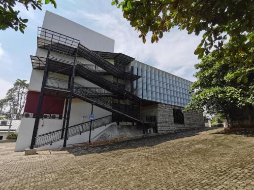 a building with stairs on the side of it at Aries Hotel Lampung in Kedaton