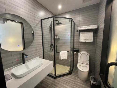 a bathroom with a shower and a sink and a toilet at Thank Inn Jiangsu Suqian Sucheng District Car Town in Suqian