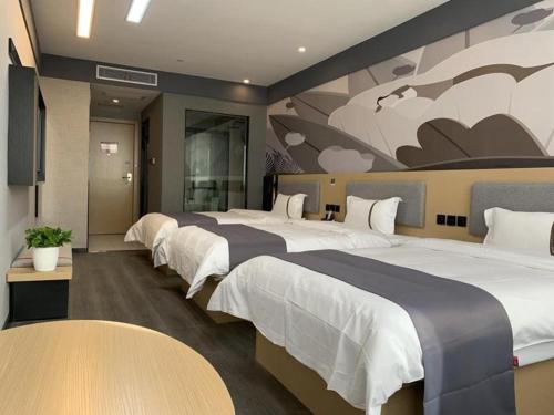 a hotel room with three beds and a mural at Thank Inn Ningxia Yinchuan Helan County Ningxia Jiaotong School in Yinchuan
