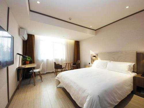 Ein Bett oder Betten in einem Zimmer der Unterkunft Hanting Hotel Hefei Baoye Dongcheng Plaza