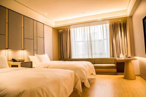 Ein Bett oder Betten in einem Zimmer der Unterkunft Ji Hotel Changzhi High-tech Zone