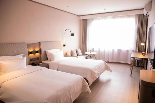 Cama ou camas em um quarto em Hanting Hotel Hohhot Jinqiao Development Zone