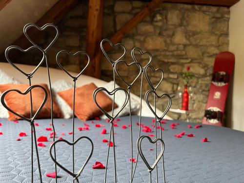 a group of heart holders on a table with red hearts at MARYS family friendly Apartments,VISIT RHINE FALLS for FREE if you stay 2 nights, SOHO 95m2 2-Bedrooms 2nd floor & SOUTH BEACH 105m2 3-Bedrooms & LOFT 115m2 3-Bedrooms Suite with Galerie,LOFT Netz 20m2, Pinball, Schaffhausen-Hemmental, Rheinfall 10 km in Schaffhausen