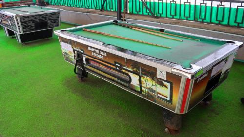 a ping pong table sitting on the grass at DefiniteHomes1 - Fully furnished studio with a rooftop restaurant near JKIA Airport, Downtown Nairobi in Nairobi