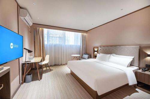 Krevet ili kreveti u jedinici u objektu Hanting Hotel Liyang Shangxing Caoshan