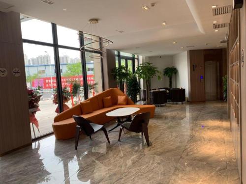 a lobby with a couch and a table in a building at Starway Hotel Lanzhou Matan Lao Street in Lanzhou