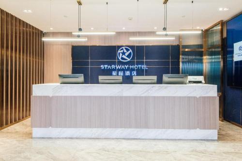 a reception desk in a showroom with a hyundai sign at Starway Hotel Lanzhou Matan Lao Street in Lanzhou