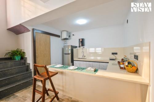 a kitchen with a counter and a chair in a room at StayVista at The Ganga House - Holy River Varanasi in Varanasi