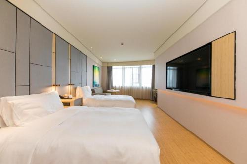 Katil atau katil-katil dalam bilik di Ji Hotel Jiaxing Nan Lake
