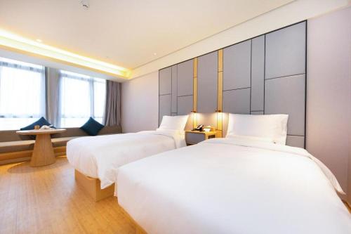 Posteľ alebo postele v izbe v ubytovaní Ji Hotel Nanjing Central Gate Jianning Road