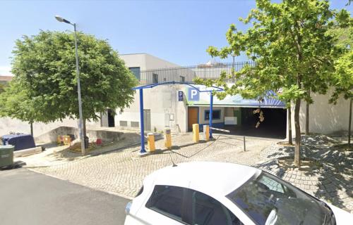 a white car parked in front of a building at Afonso Galo Guest Apartments III in Almada