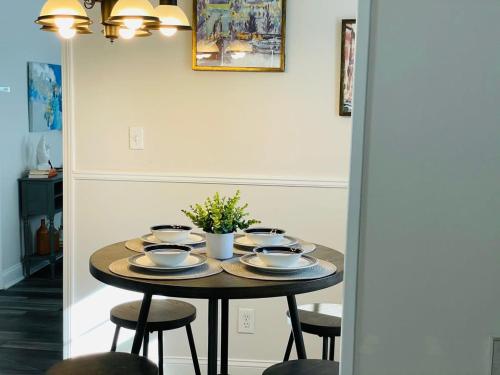 a table with plates and bowls on it in a room at Large Renovated Cottage on East Lake Park in Birmingham