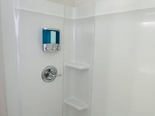 a shower with a glass door in a bathroom at Large Renovated Cottage on East Lake Park in Birmingham