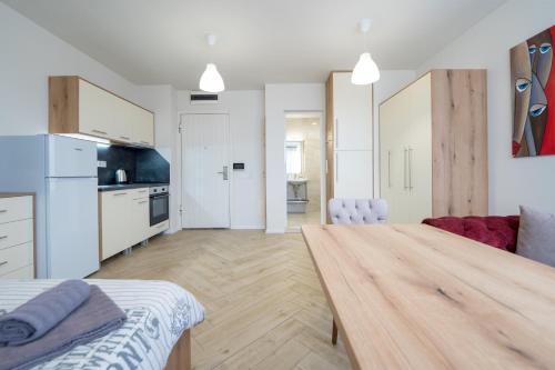 a kitchen and a living room with a wooden table at WOW studios for rent - bul Montevideo 25A - B in Sofia