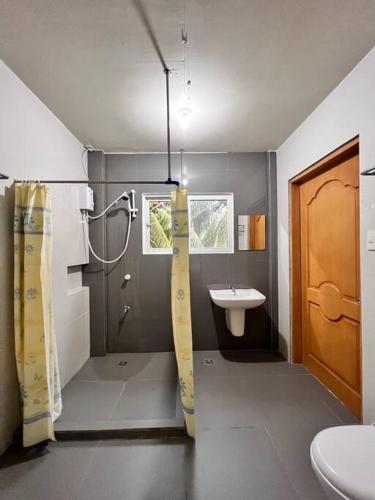 a bathroom with a shower and a sink at Oslob Seacoast Resort in Oslob
