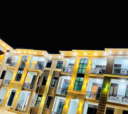 a large building with lights on it at night at Entire Furnished Apartment Unit in Kira in Kira