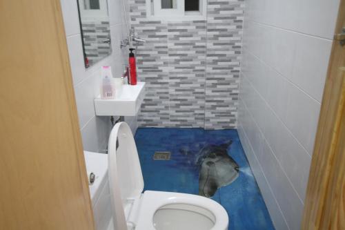 a bathroom with a dolphin painted on the floor at Time Travelers Party Hostel In Hongdae in Seoul