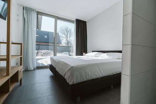 Postel nebo postele na pokoji v ubytování Ridderstee Ouddorp Duin