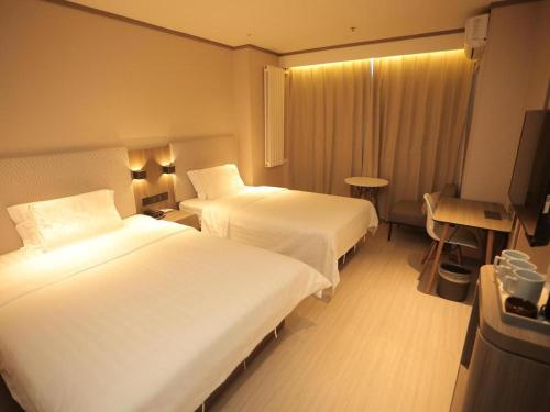 Krevet ili kreveti u jedinici u okviru objekta Hanting Hotel Sanhe Yanjiao Development Zone