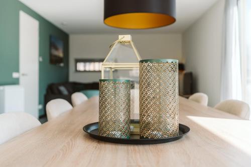 two lanterns sitting on top of a wooden table at Ridderstee Ouddorp Duin in Ouddorp
