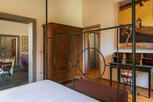 a bedroom with a bed with a iron bed frame at Castello di Lispida in Monselice