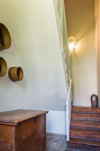a room with a staircase and a wooden table at Castello di Lispida in Monselice