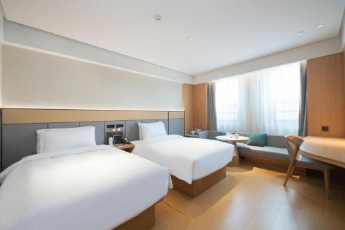 Säng eller sängar i ett rum på Ji Hotel Zhengzhou Convention and Exhibition Center Weilai Road