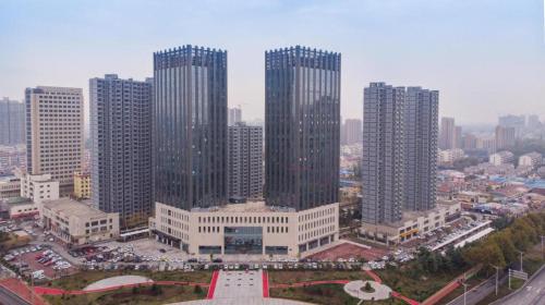 a group of tall buildings in a city at Ji Hotel Heze Renmin Road in Heze