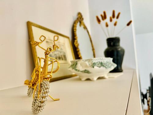a shelf with gold objects on a table at Top floor 1BR apartment central Matlock in Matlock