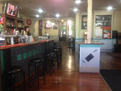 a bar with stools and a counter in a restaurant at Budget Motel in Midland Junction