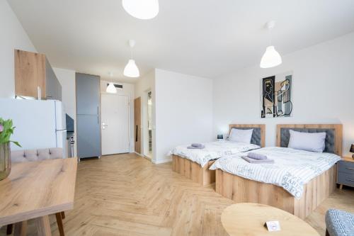 a room with two beds and a table in it at WOW studios for rent - bul Montevideo 25A - B in Sofia