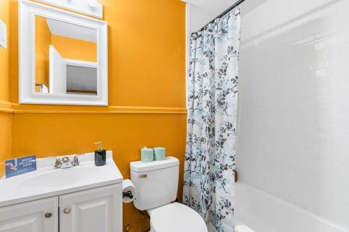 a bathroom with a toilet and a sink and a mirror at The Bricks - Apt 3 in Birmingham