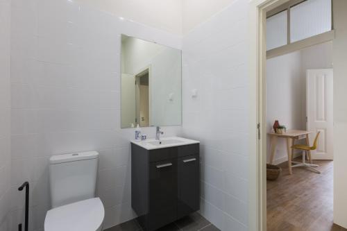 a white bathroom with a sink and a toilet at Rua Augusta Dream Apartment in Lisbon
